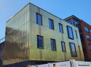 Gold metal clad buidling. RCI Magazine Facade Awards 2021!