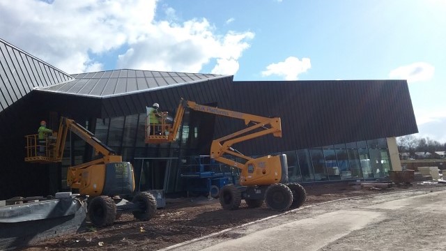 Zinc roofing and cladding Astley Point Longworth and client conducting QA on feature roof